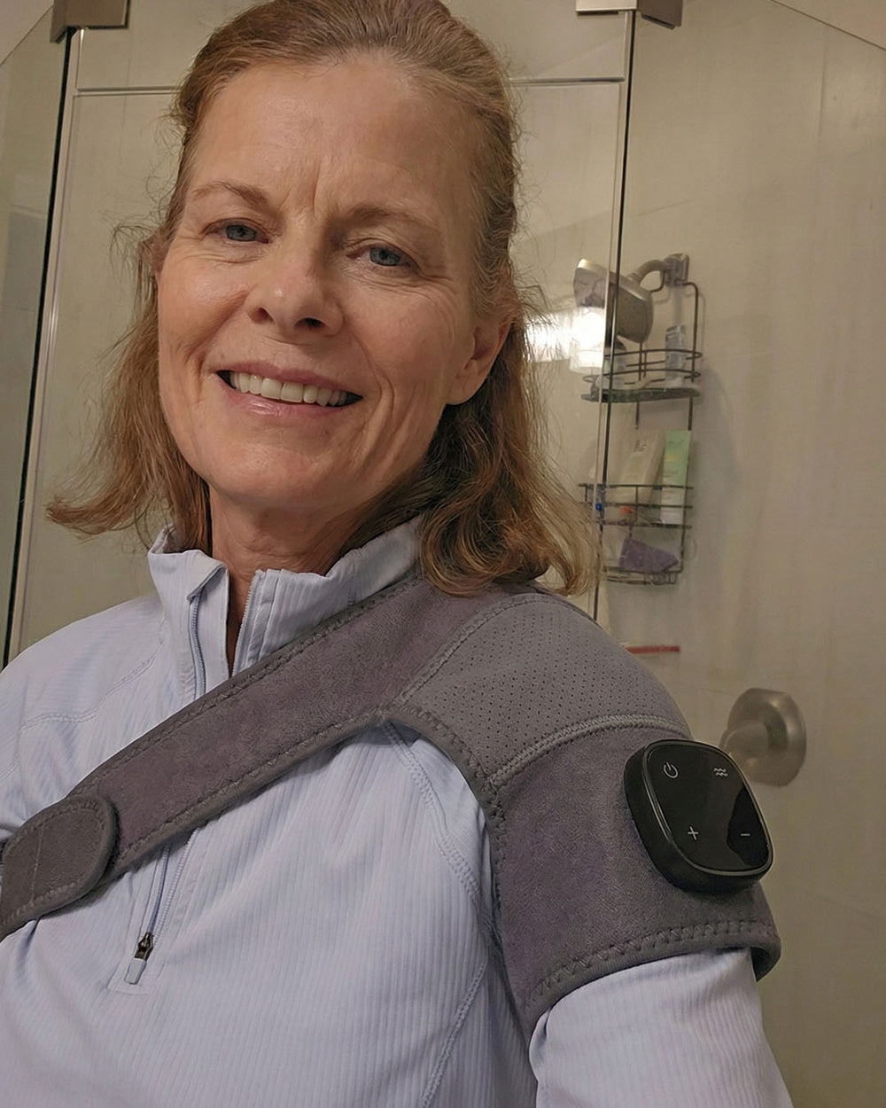 Woman wearing a shoulder brace in a bathroom